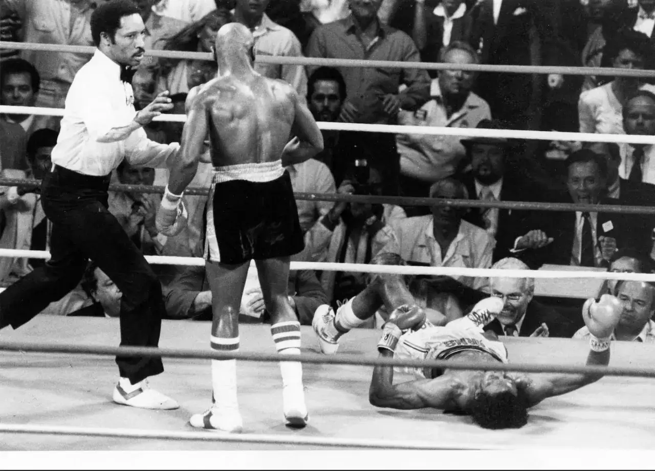 Marvin Hagler war: A referee watches as a boxer lies on the canvas, defeated.