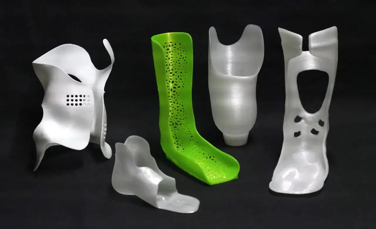 A collection of custom orthopedic braces and prosthetic sockets, showcasing the versatility of polypropylene 3D printing for personalized medical devices.