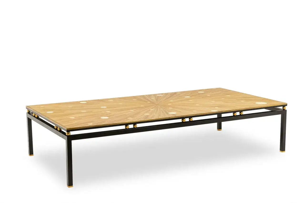 Table basse rectangulaire avec un plateau en marqueterie contemporaine aux motifs rayonnants et circulaires. Structure m&eacute;tallique noire avec des ornements dor&eacute;s.