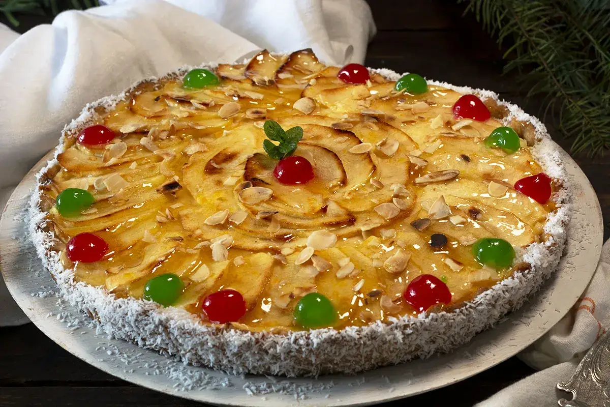 Tarta de manzana glaseada, decorada con almendras laminadas, cerezas rojas y verdes. Perfecta para tus recetas con manzanas.