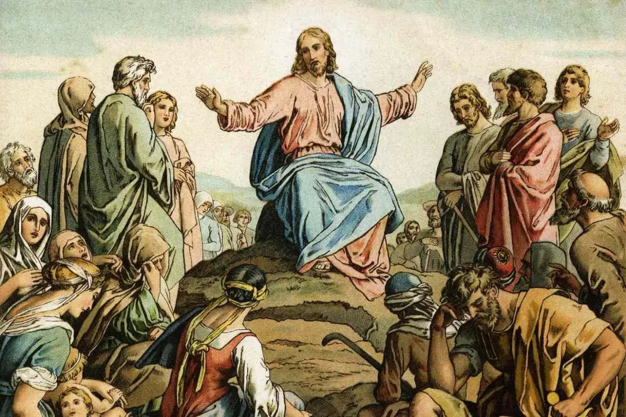 Jesus preaches the Beatitudes Catholic to a crowd gathered on a hillside.