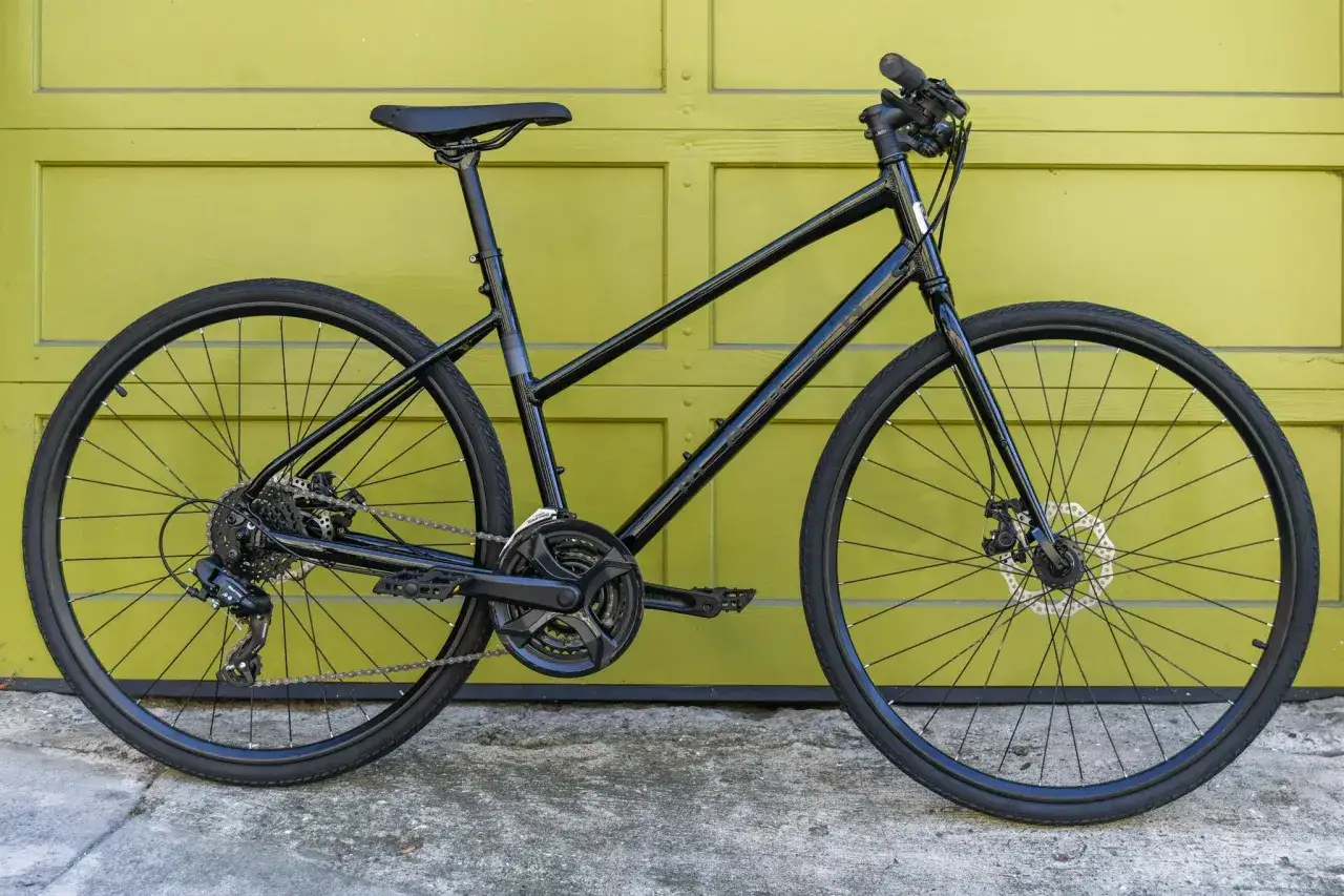 A sleek black commuter bike vs hybrid, ready for city streets or light trails.