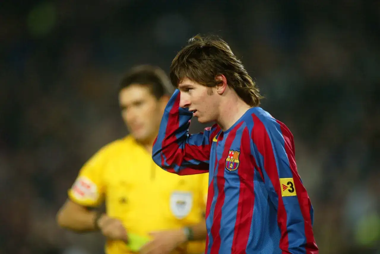 Młody Messi w kultowej koszulce FC Barcelona, z charakterystycznym numerem 3 na rękawie.