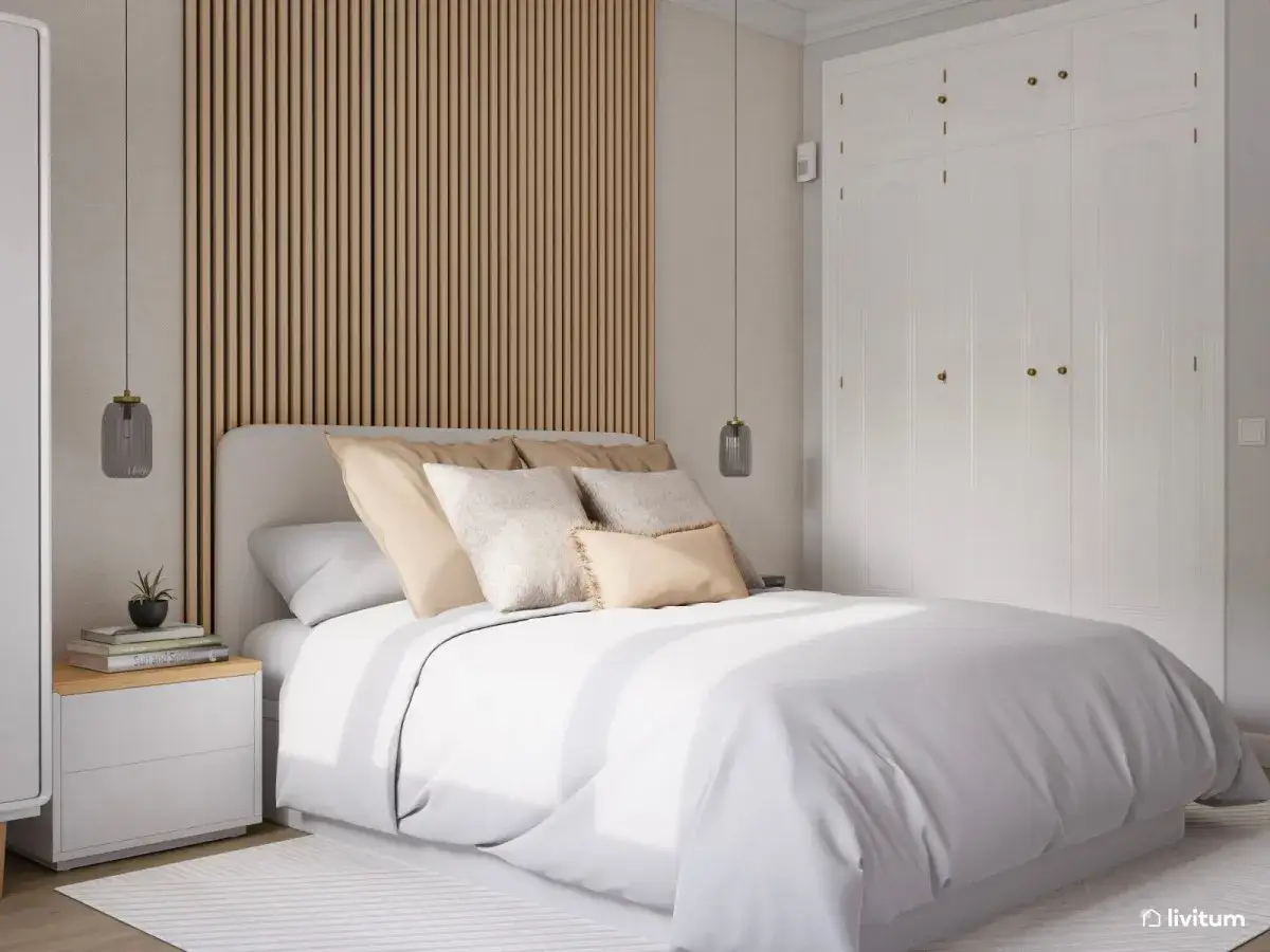 Acogedora habitación con decoración nórdica: cama con ropa de cama blanca, cabecero tapizado, mesita de noche y armario blanco.