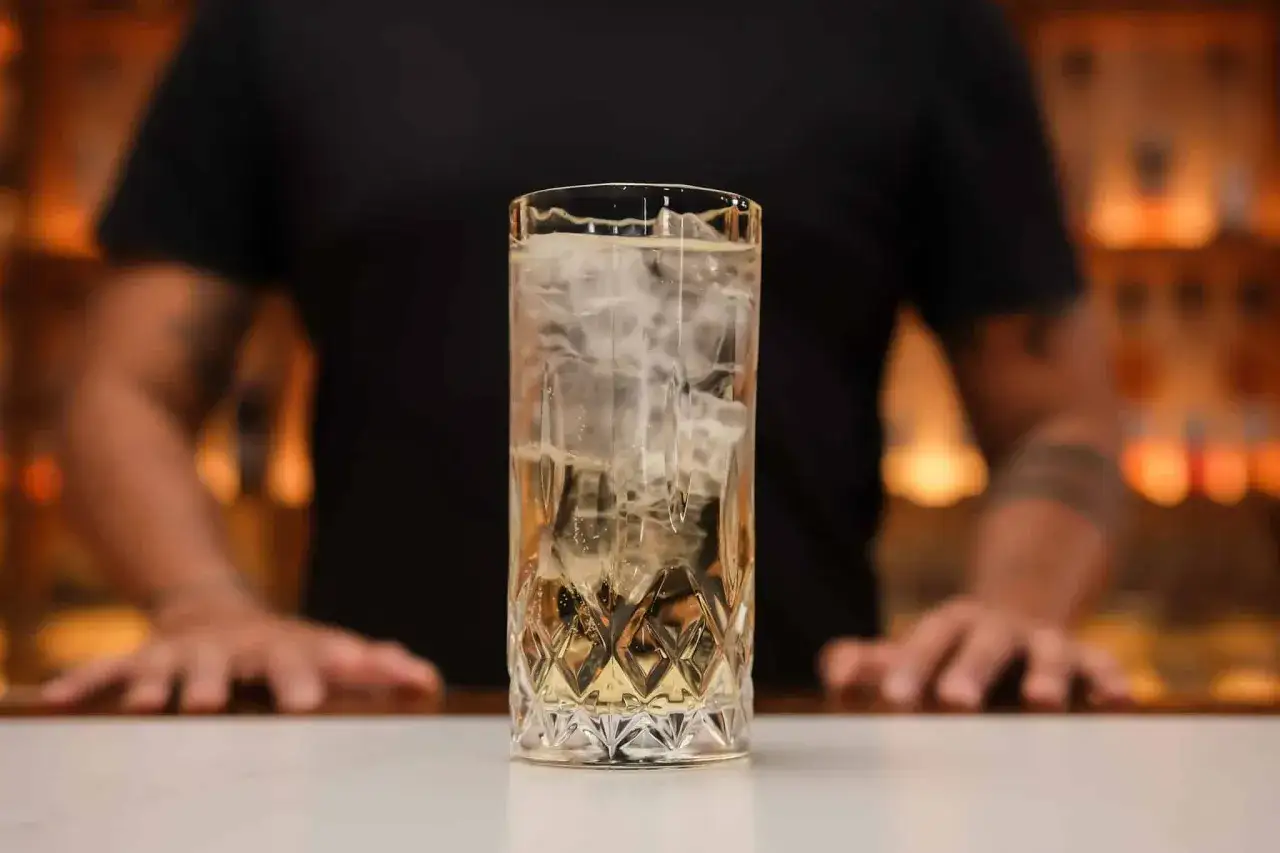 Orzeźwiające whisky z tonikiem, pełne lodu, w eleganckiej szklance. Idealne na wieczór.