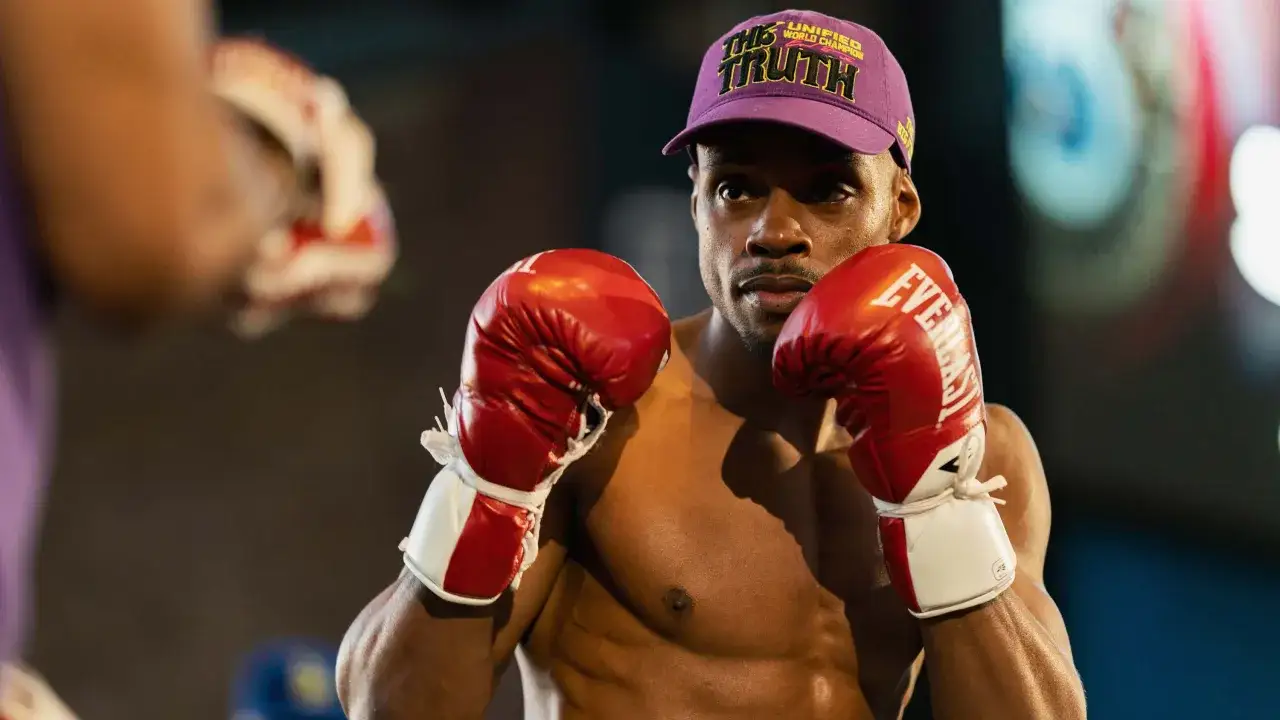 Errol Spence Jr. in boxing stance, wearing red gloves and a purple