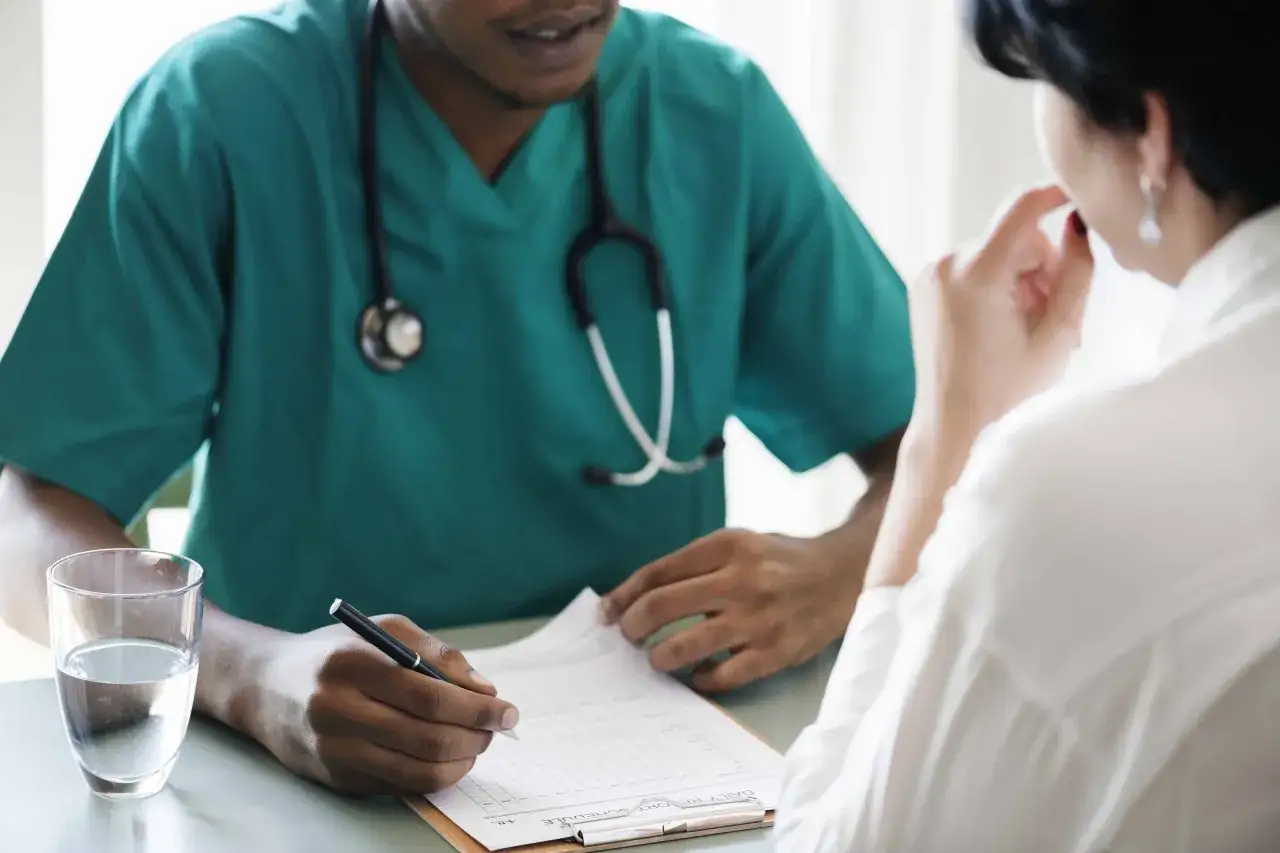 Doctor talking to patient about symptoms