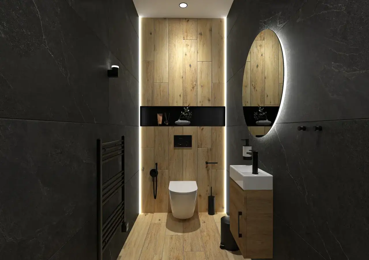 Salle de bain moderne avec murs en ardoise noire, sol en bois et **déco WC noir et bois** élégante. Miroir rond lumineux et lavabo suspendu.