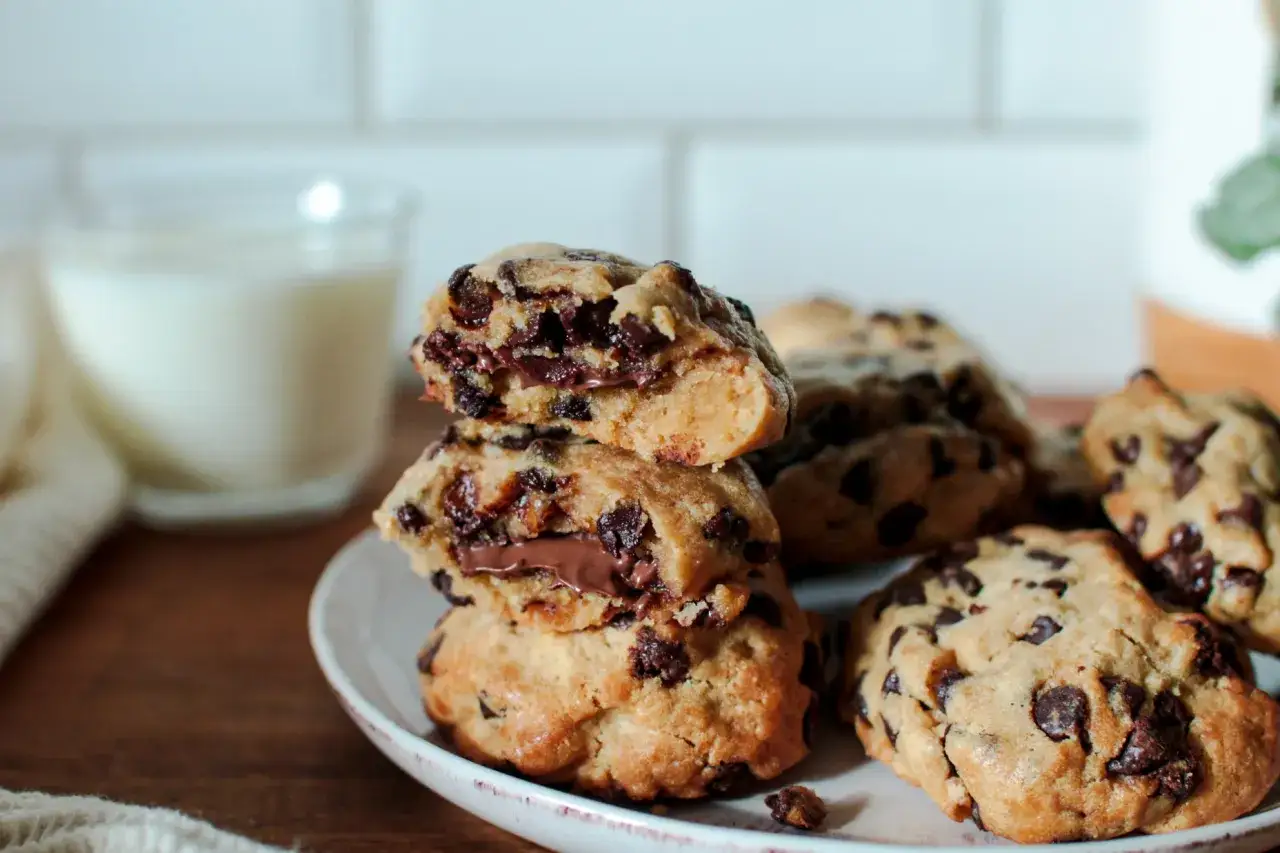 Gourmands cookies aux pépites de chocolat, parfaits pour une recette cookies facile. Un verre de lait à côté pour le plaisir.