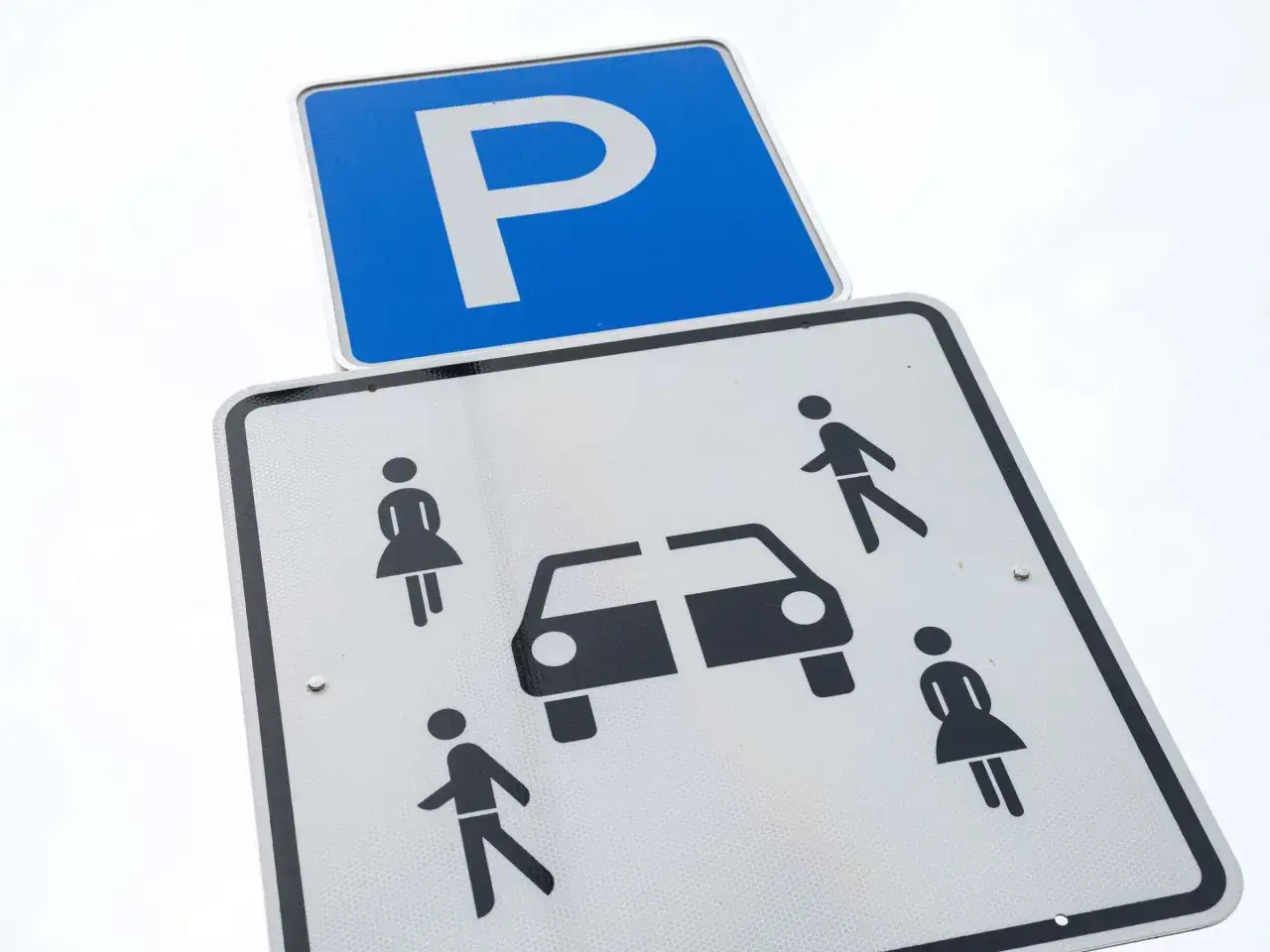 Zwei Parkschilder: oben ein blaues Schild mit weißem