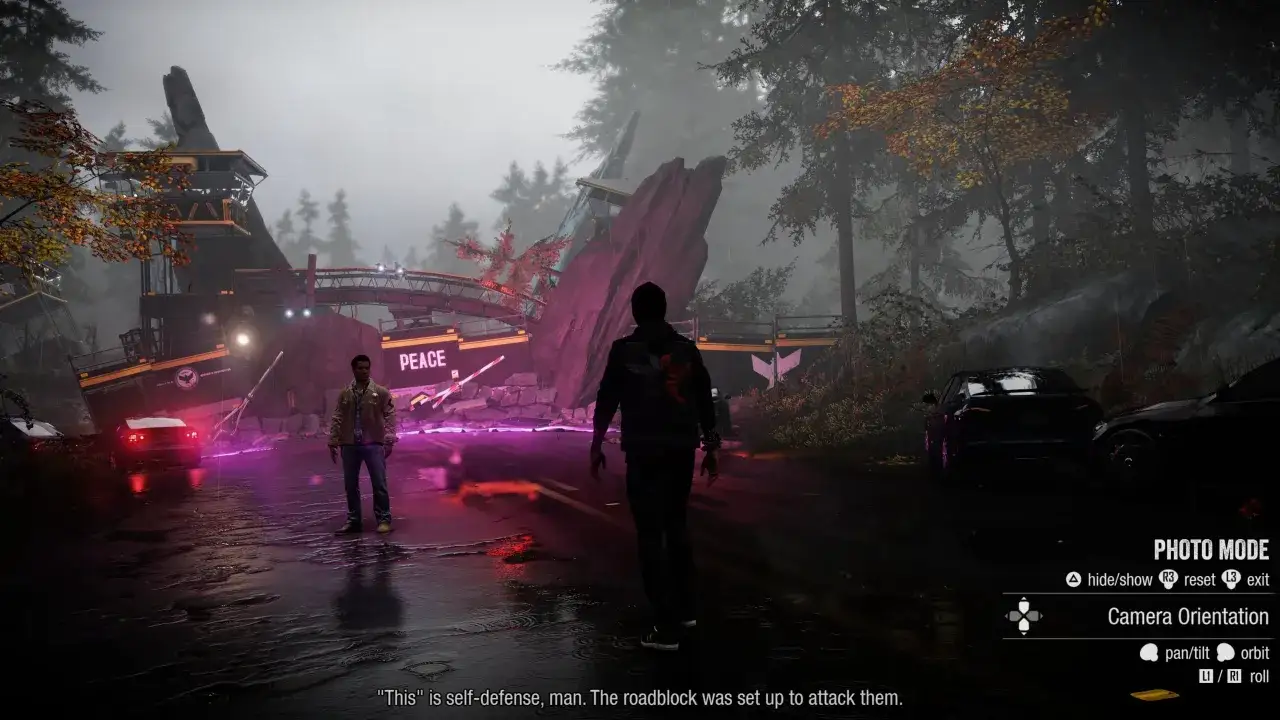 Dwaj mężczyźni stoją przy zniszczonej drodze w grze Infamous Second Son. Jeden z nich mówi: 