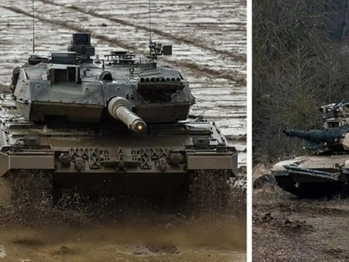 Leopard 2 k&auml;mpft sich durch Schlamm, w&auml;hrend ein M1 Abrams im Wald lauert. Ein Duell der Panzer.