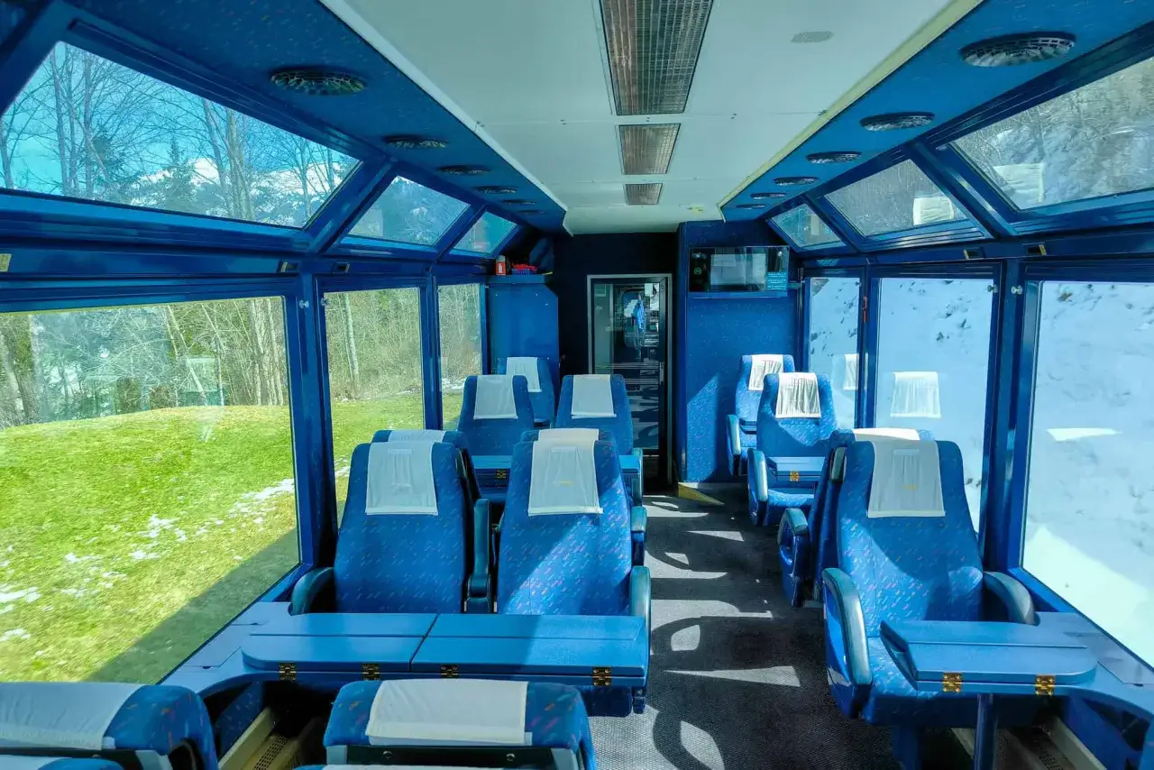 Experience the Golden Pass Belle Époque vs. panoramic views from these plush blue seats. A journey through stunning landscapes awaits.