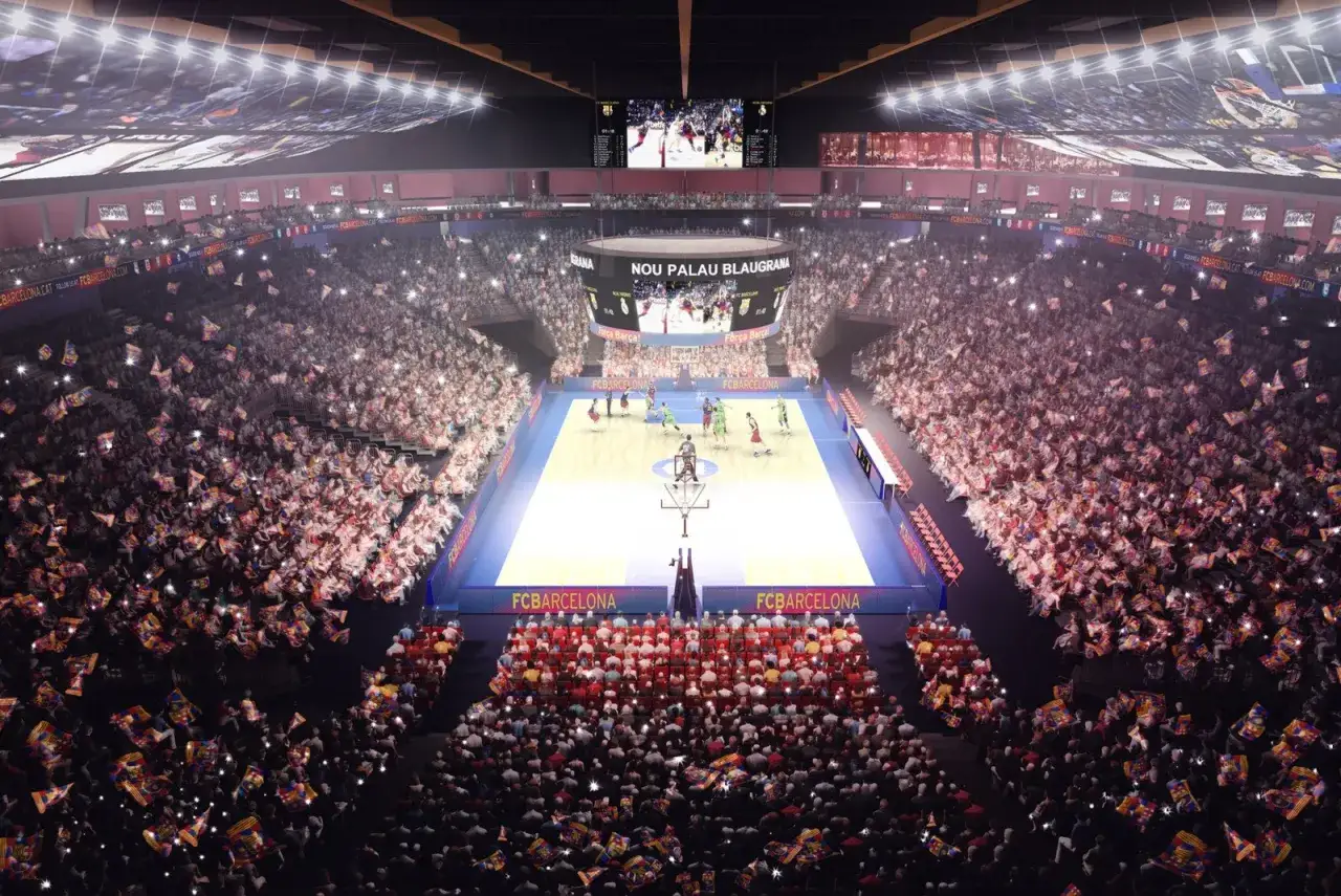 Widownia na meczu FC Barcelona handball w hali Nou Palau Blaugrana. Kibice z flagami świętują zwycięstwo.