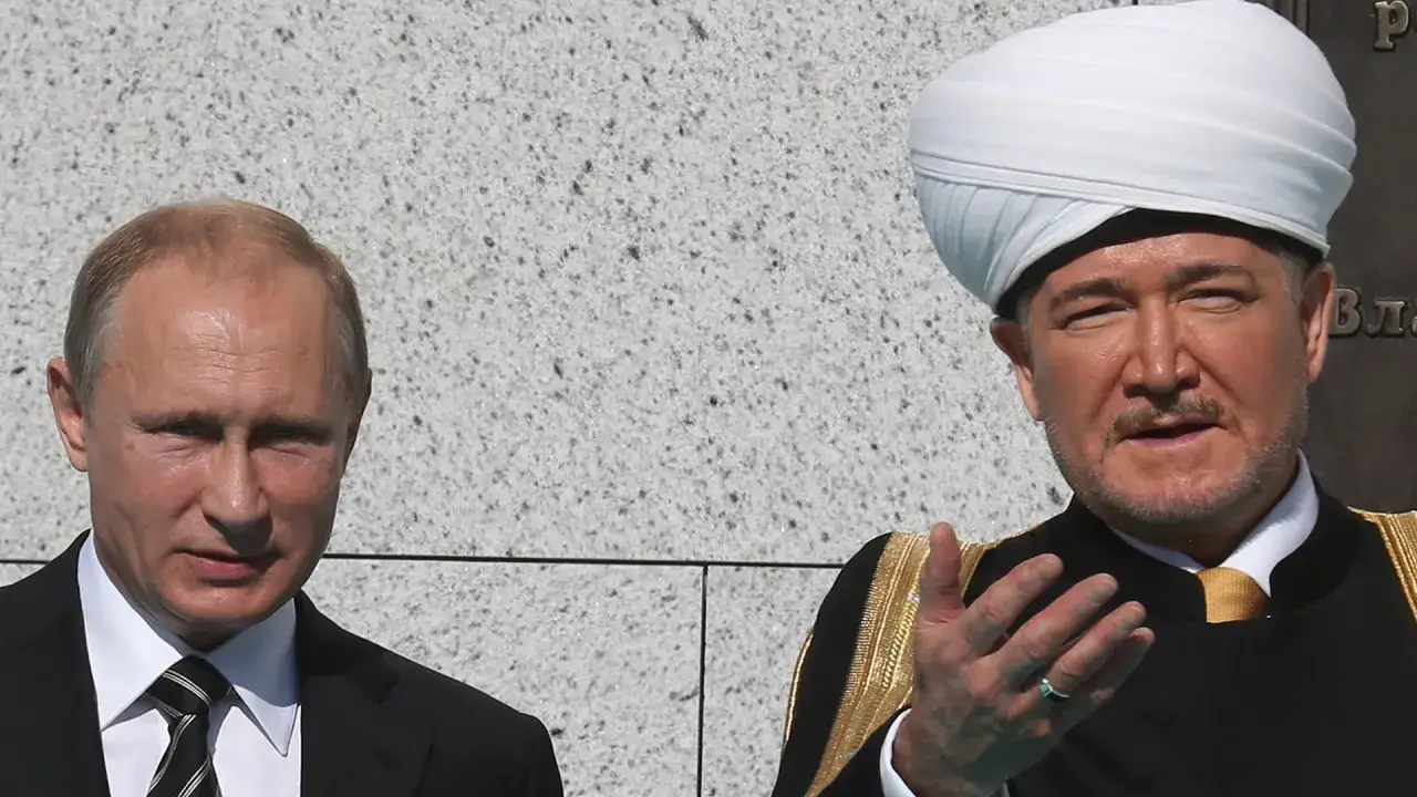 Putin im Gespräch mit einem Geistlichen im Turban. Ein Treffen, das die Beziehungen zwischen Russland und dem Islam beleuchtet.