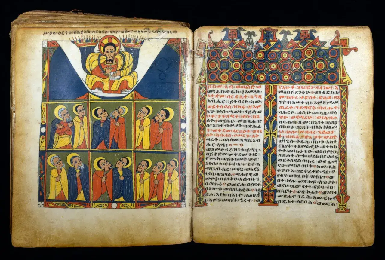 Starożytna biblia etiopska z barwnymi ilustracjami. Na lewej stronie przedstawiono scenę z postaciami w ozdobnych strojach, a na prawej tekst w języku ge'ez.