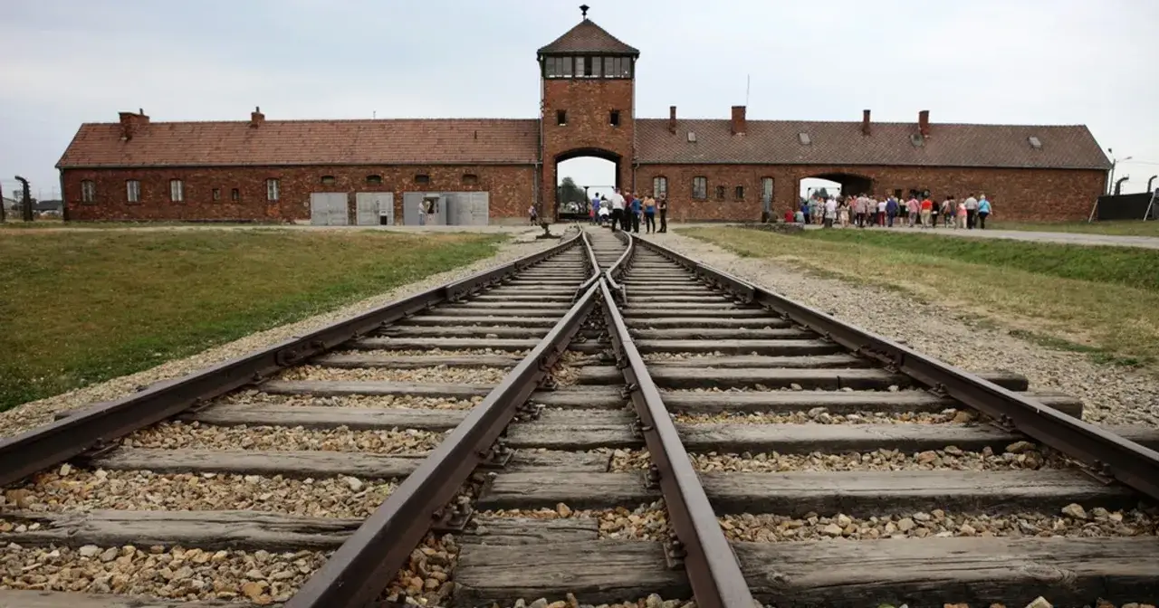 Tory kolejowe prowadzące do bramy obozu Auschwitz-Birkenau. Miejsce pamięci, które budzi refleksje, jak wskazują państwowe muzeum auschwitz-birkenau w oświęcimiu opinie.