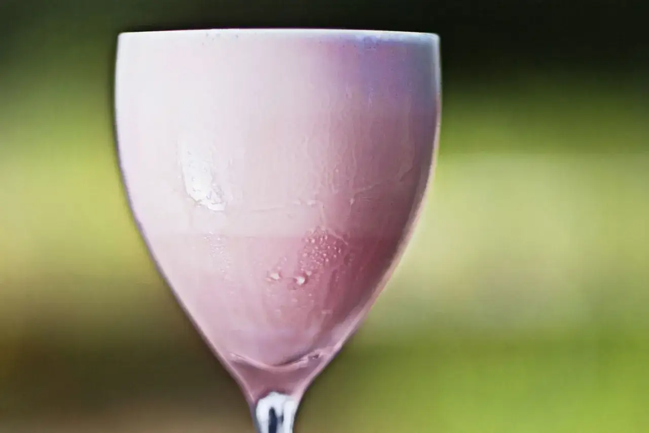 Ett glas med en rosa amarula drink, med kondens på glaset.