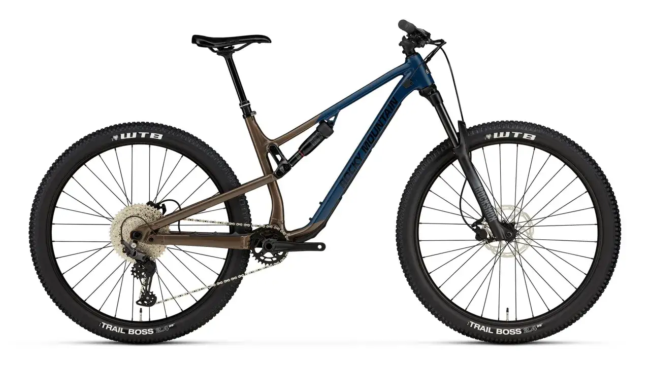 A blue and brown Rocky Mountain bike, a full-suspension soft tail, ready for trails. This contrasts with a hard tail, offering a smoother ride.