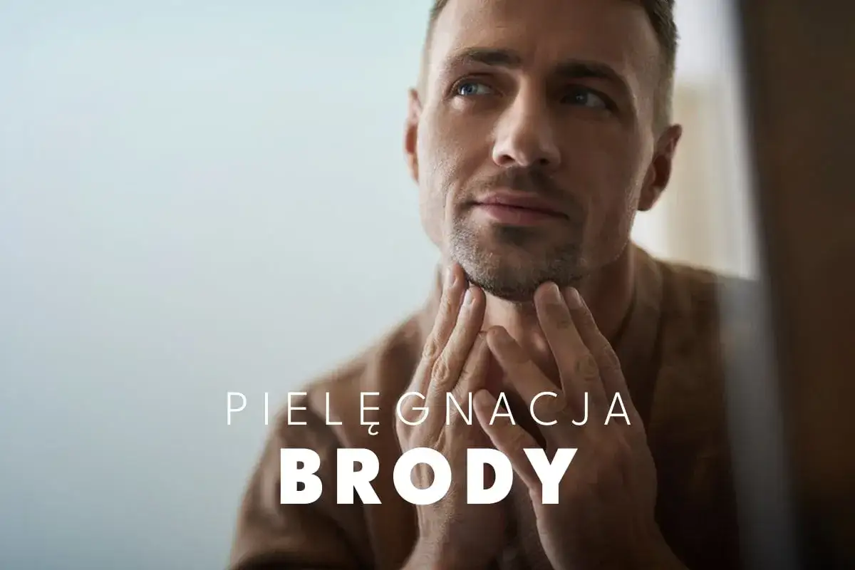 Mężczyzna z zadbaną brodą dotyka jej palcami, zastanawiając się, jak pielęgnować brodę. Tekst: Pielęgnacja Brody.