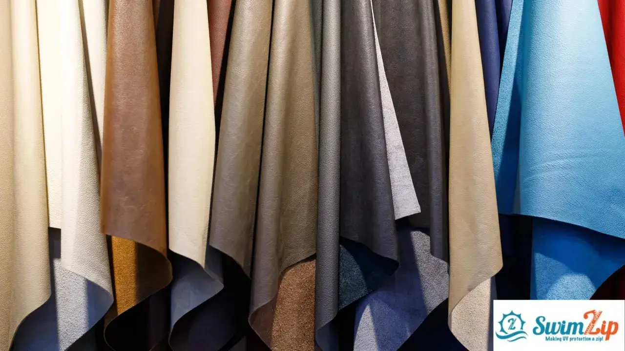 A variety of textured fabrics in neutral and bright colors hang in folds. This could be the perfect swim fabric for your next project.