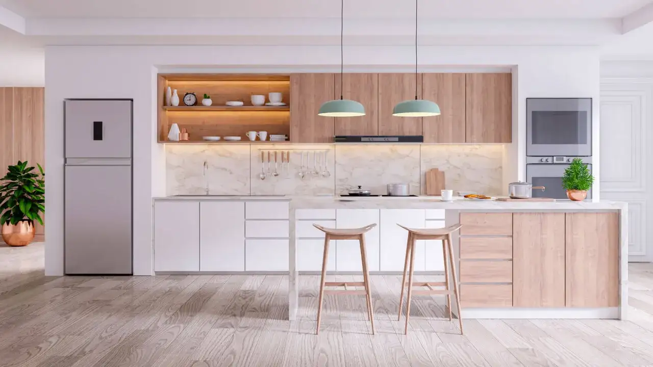 Elegante cucina in cartongesso con isola centrale, elettrodomestici moderni e finiture in legno chiaro.