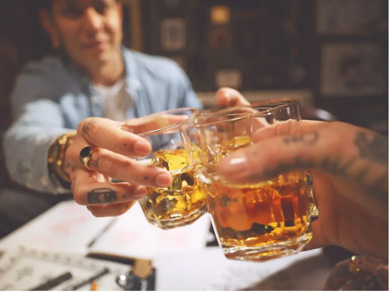 Dwie osoby wznoszą toast whisky. Zastanawiasz się, ile cukru jest w whisky? To pytanie często pojawia się przy degustacji.