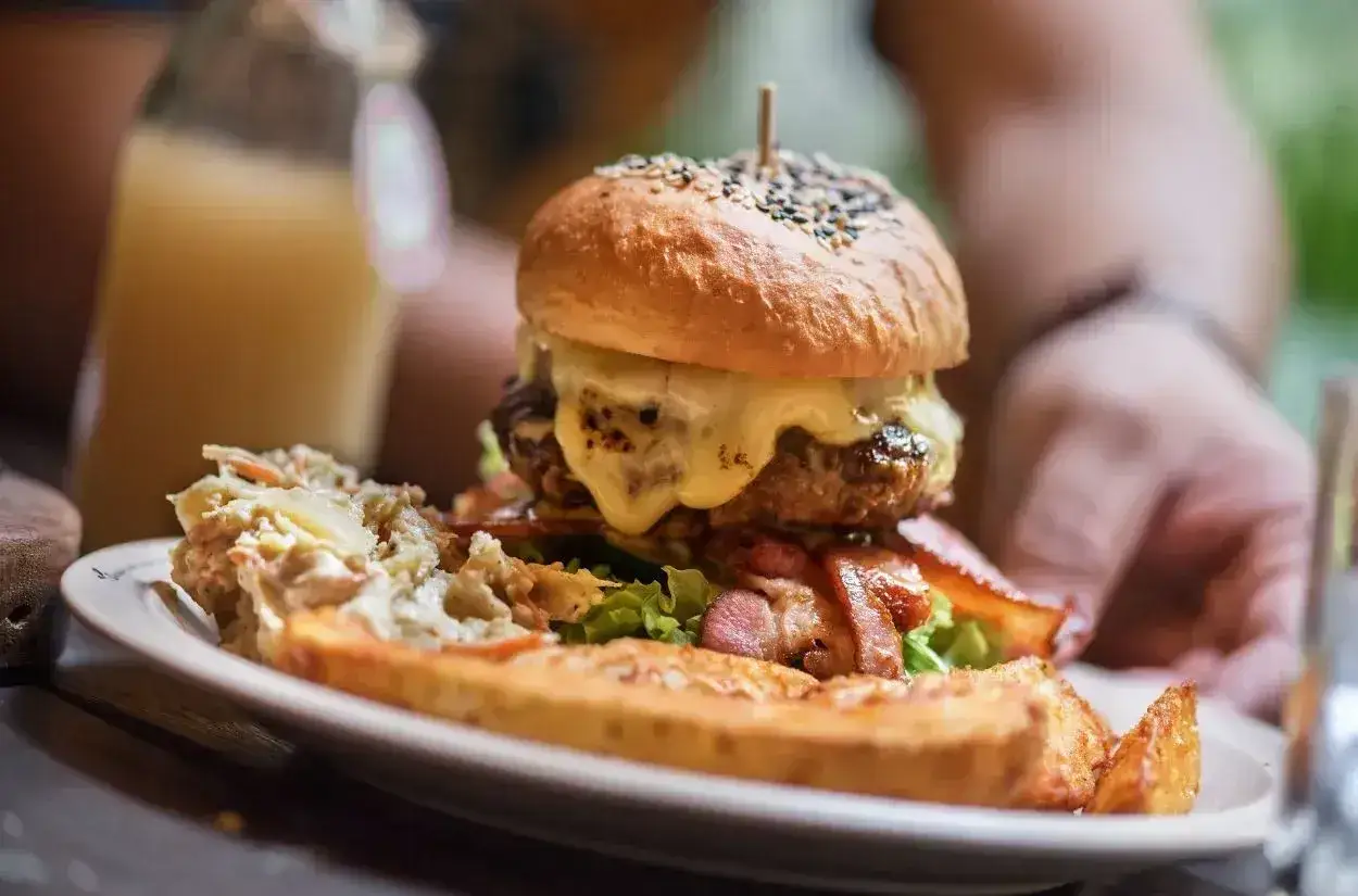 Pyszny burger drwala przepis na obiad. Soczysta wołowina, ser, bekon i frytki.