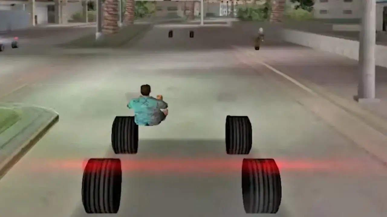 Postać w koszuli siedzi na ziemi, otoczona kołami pojazdu. To scena z gry, gdzie gracze szukają kodów do GTA Vice City.