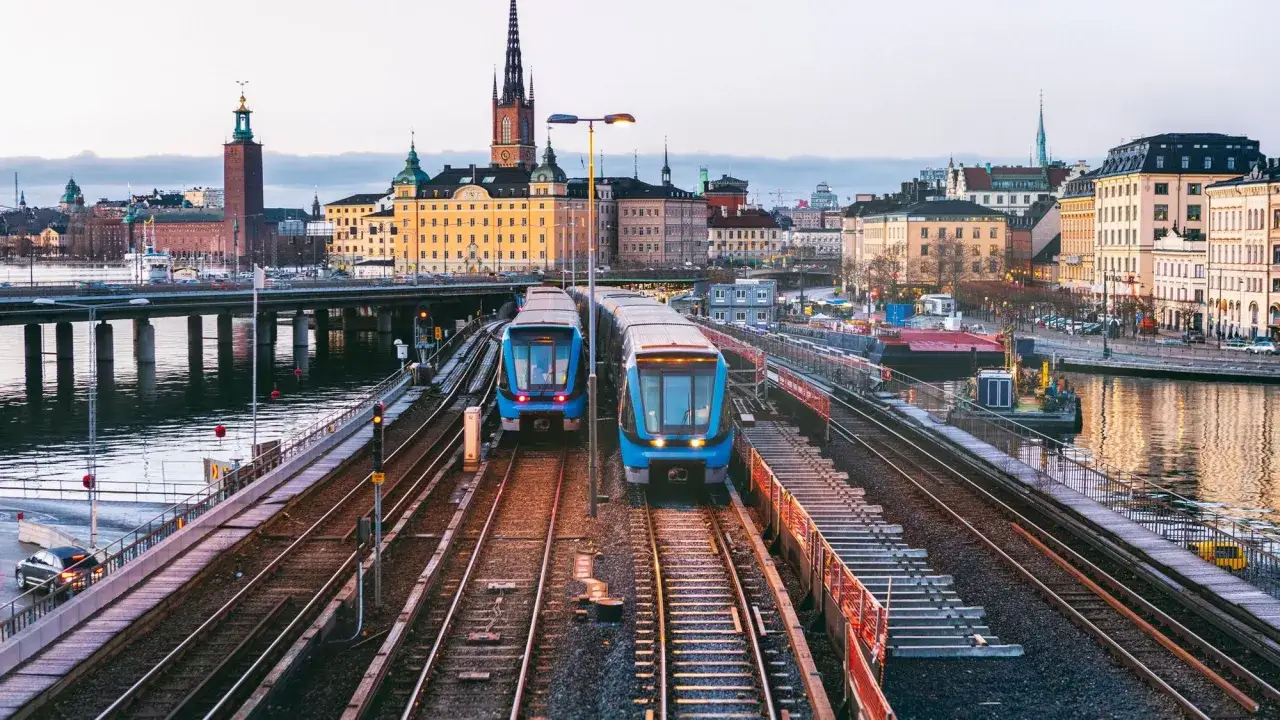 Two blue trains on tracks in Stockholm, a perfect start to a 3 month Europe itinerary.