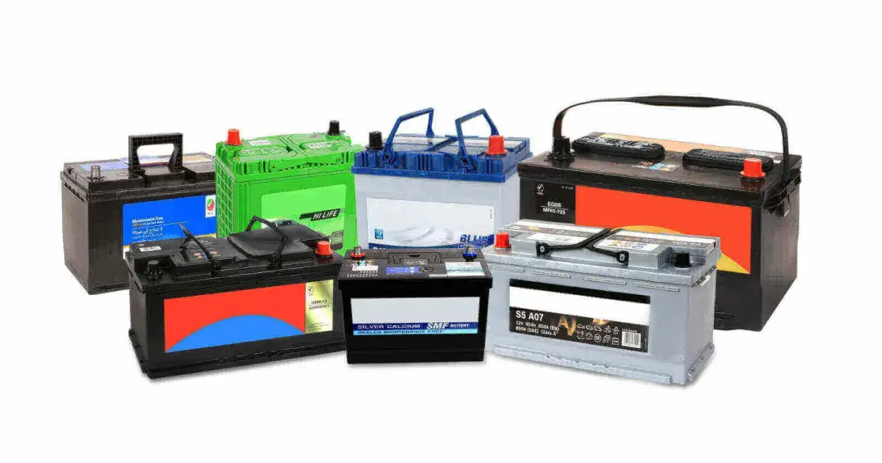 A variety of car battery types are displayed, including green, black, and silver models, showcasing different brands and designs.