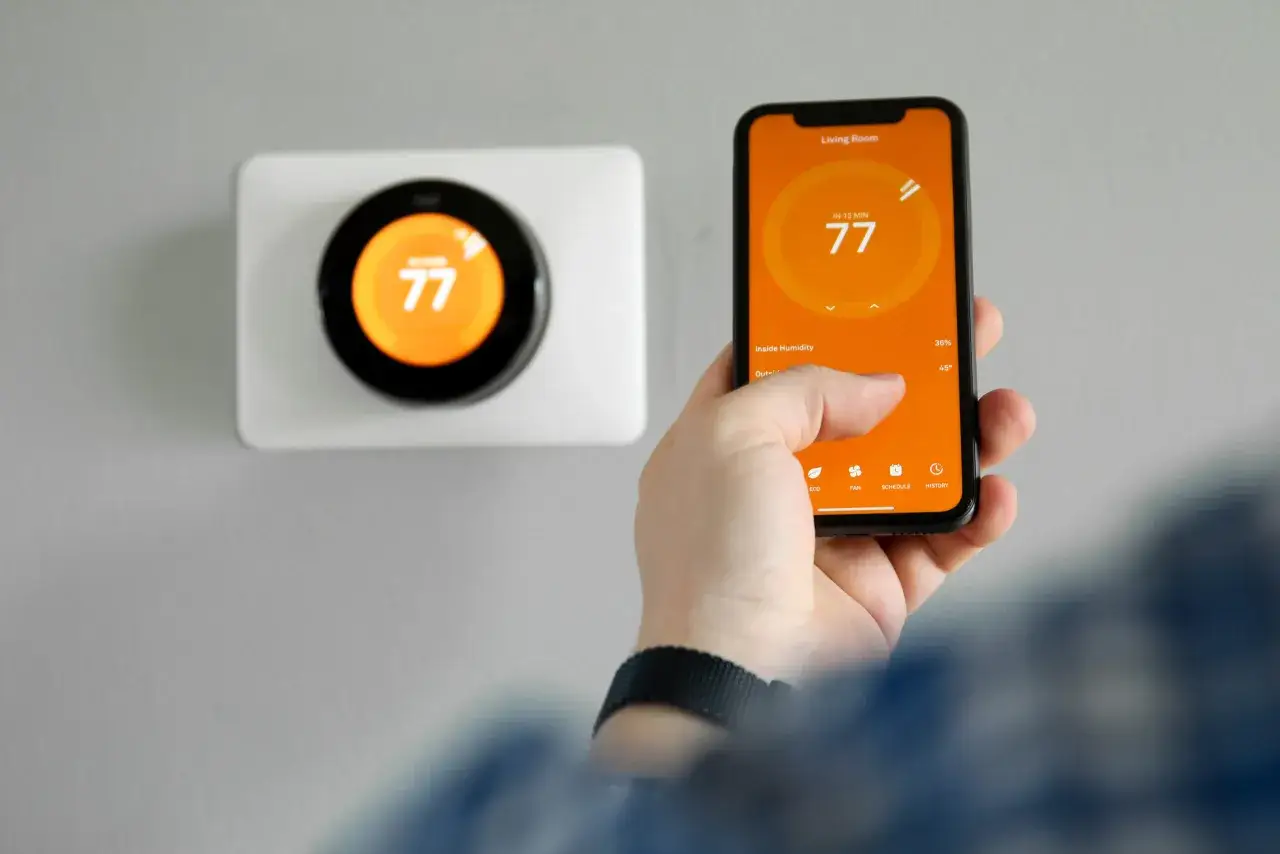 Un termostato smart controllato da smartphone. La temperatura impostata &egrave; 77 gradi.