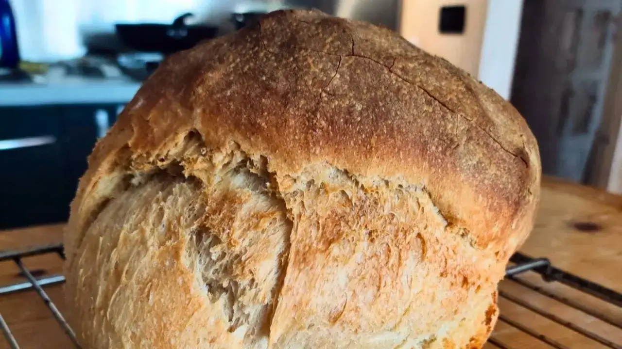 Pane morbido fatto in casa, dorato e fragrante, con una crosta leggermente screpolata. Perfetto per ogni pasto.