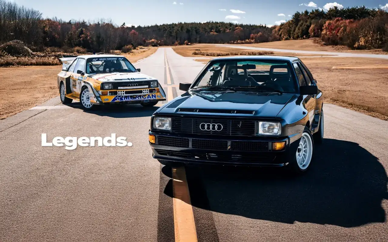 Dwa kultowe Audi quattro S1 na drodze. Jeden w rajdowym malowaniu, drugi czarny, lśniący.
