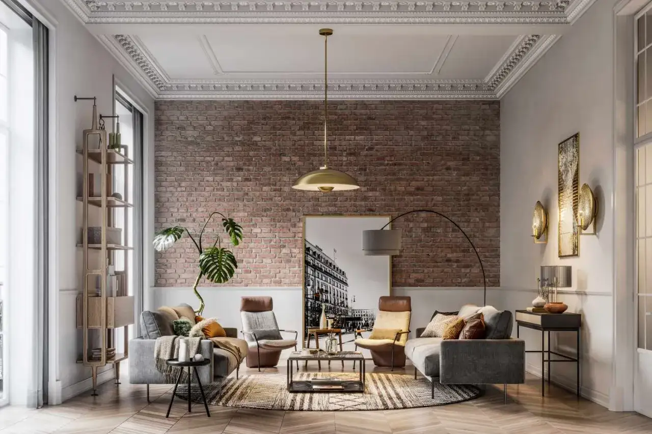 Sal&oacute;n moderno con una imponente pared de ladrillo visto, sof&aacute;s grises, sillones de cuero y una planta exuberante.