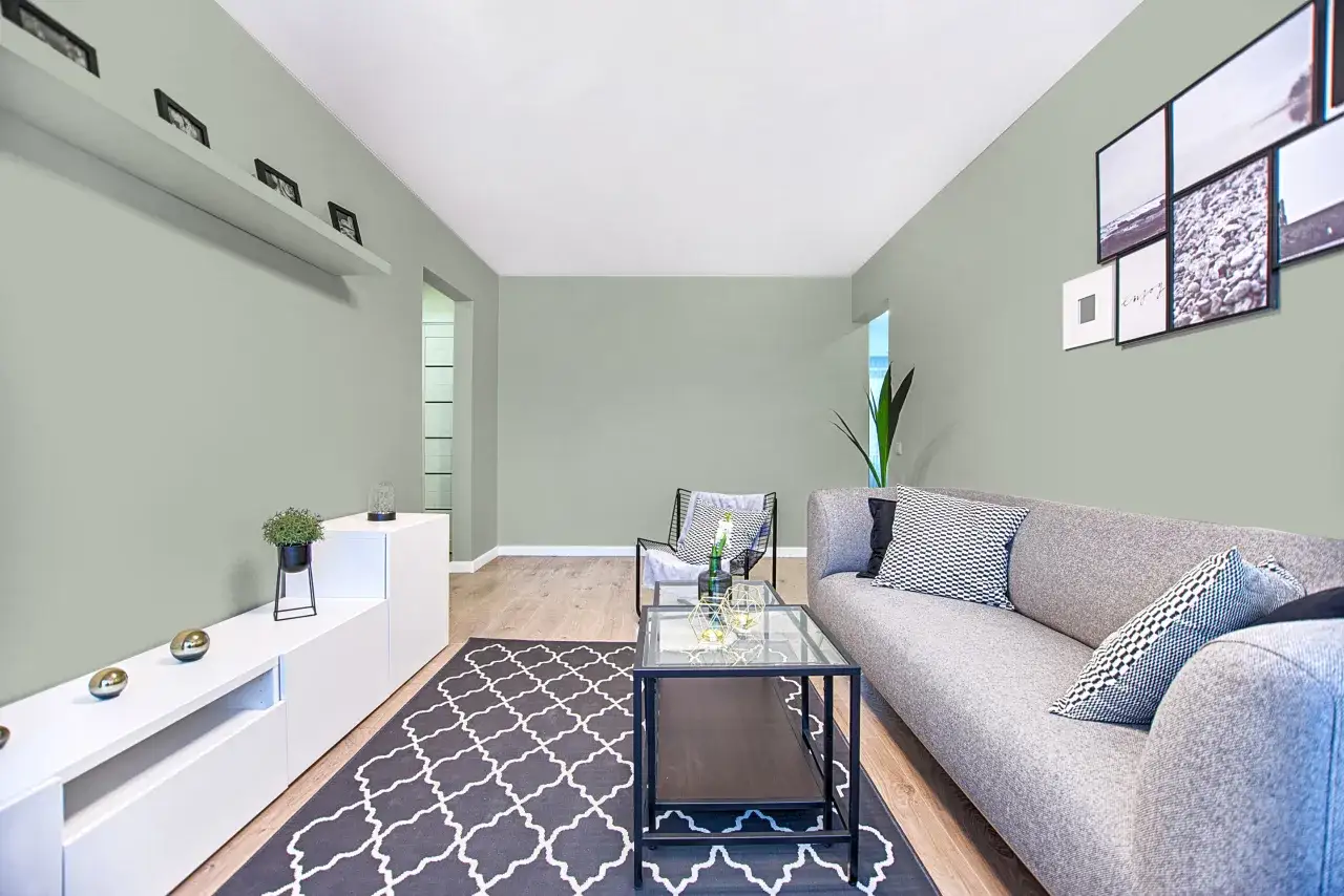 Un salon moderne avec un canap&eacute; gris, un tapis graphique et des &eacute;tag&egrave;res murales. Des touches de d&eacute;coration minimalistes pour comment agrandir une pi&egrave;ce.