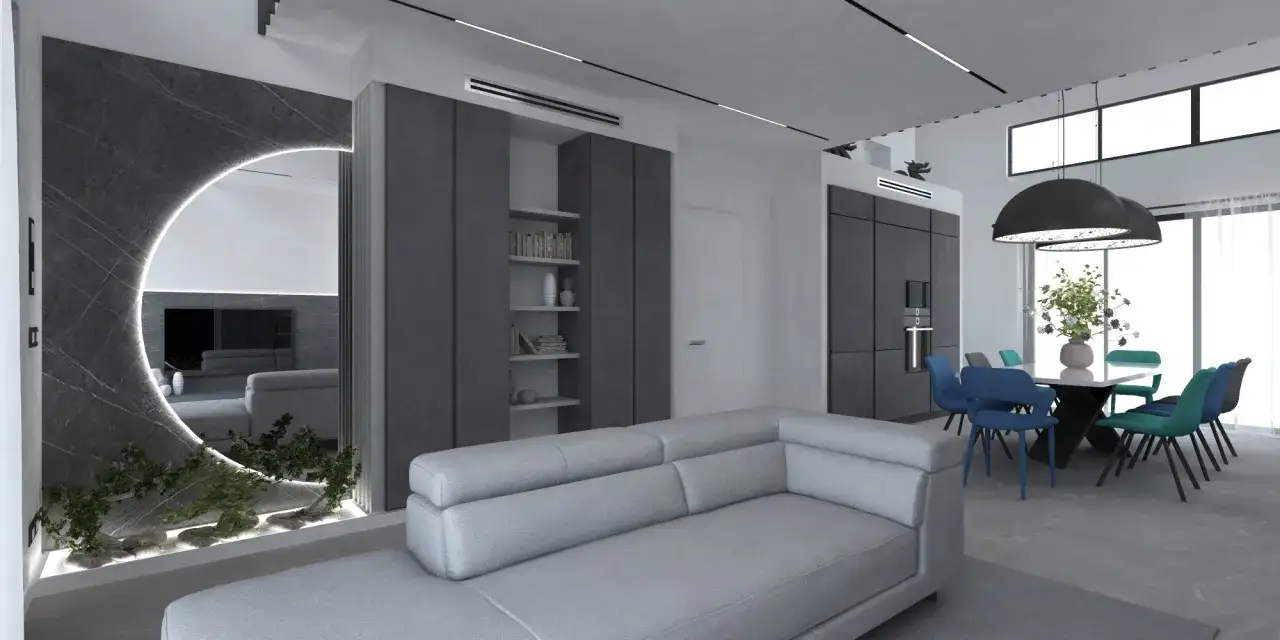 Soggiorno moderno con divano grigio, specchio circolare illuminato e zona pranzo con sedie colorate.