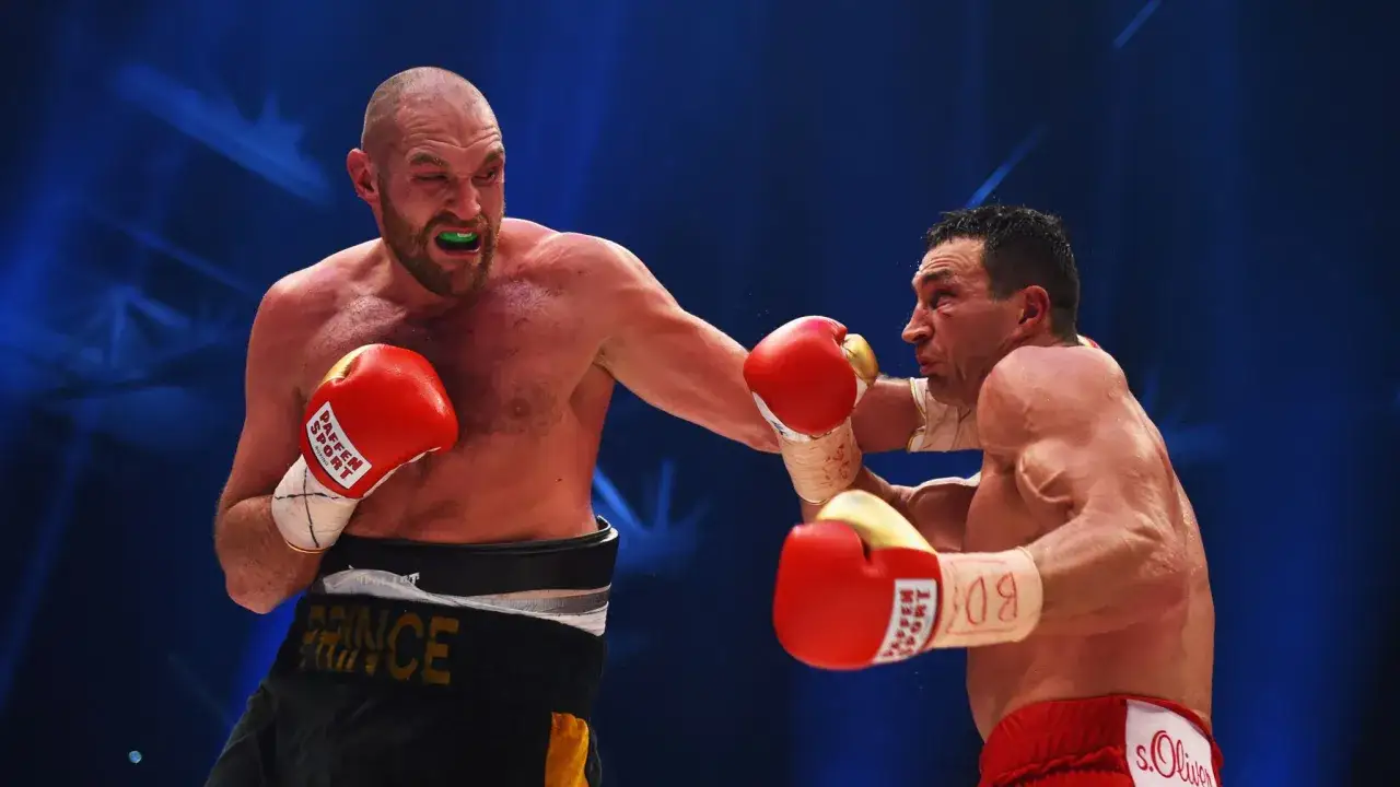 Tyson Fury lands a punch on Wladimir Klitschko during their heavyweight championship fight.