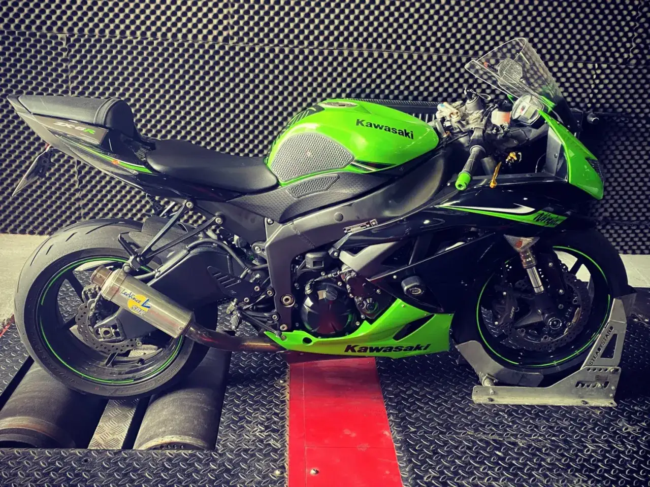 Zielona Kawasaki Ninja na hamowni, gotowa do blokowania motocykla na A2.