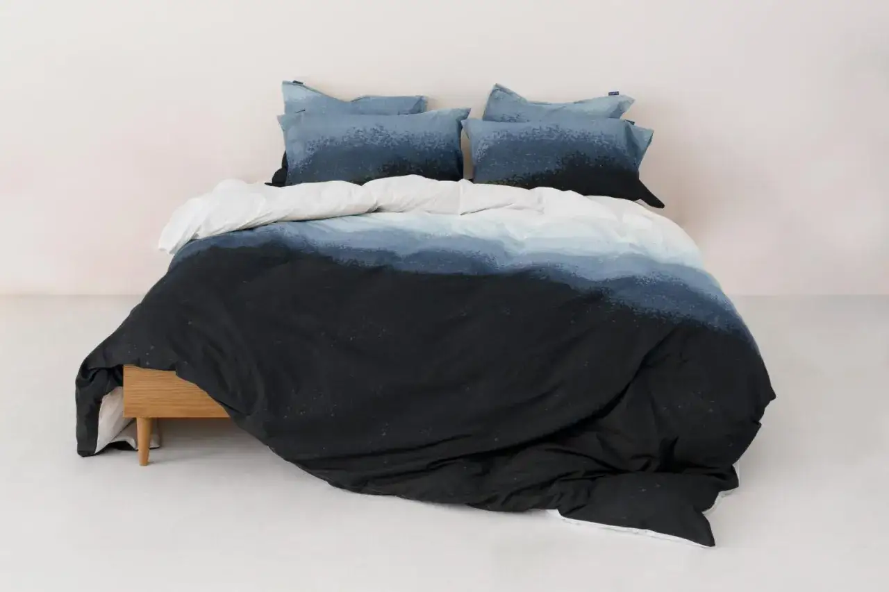 Funda nórdica 180x220 con diseño degradado en tonos azules y negros, como olas oscuras.