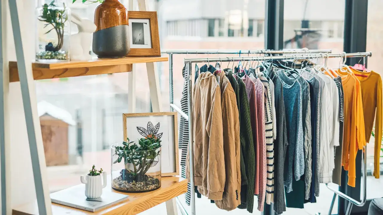 Percheros con ropa de diferentes colores y texturas, ideal para inspirarte sobre cómo encontrar tu estilo personal.