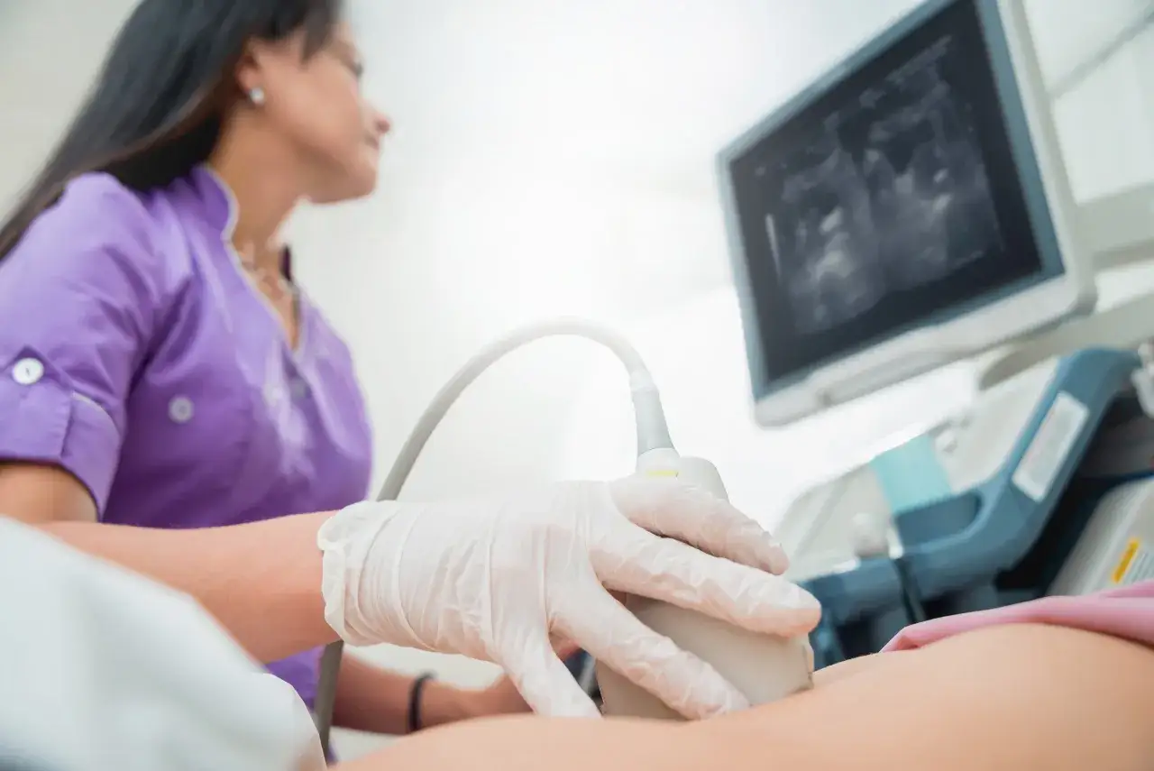 Lekarz wykonuje USG jamy brzusznej, by zdiagnozować ból brzucha i krwawienia z pochwy.