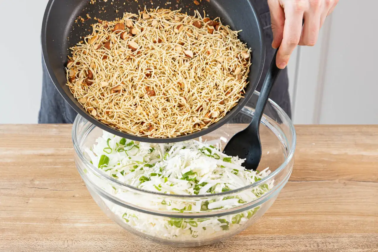Knusprige Nudeln und Mandeln werden über einen Kohl-Frühlingszwiebel-Salat gegossen. Ein