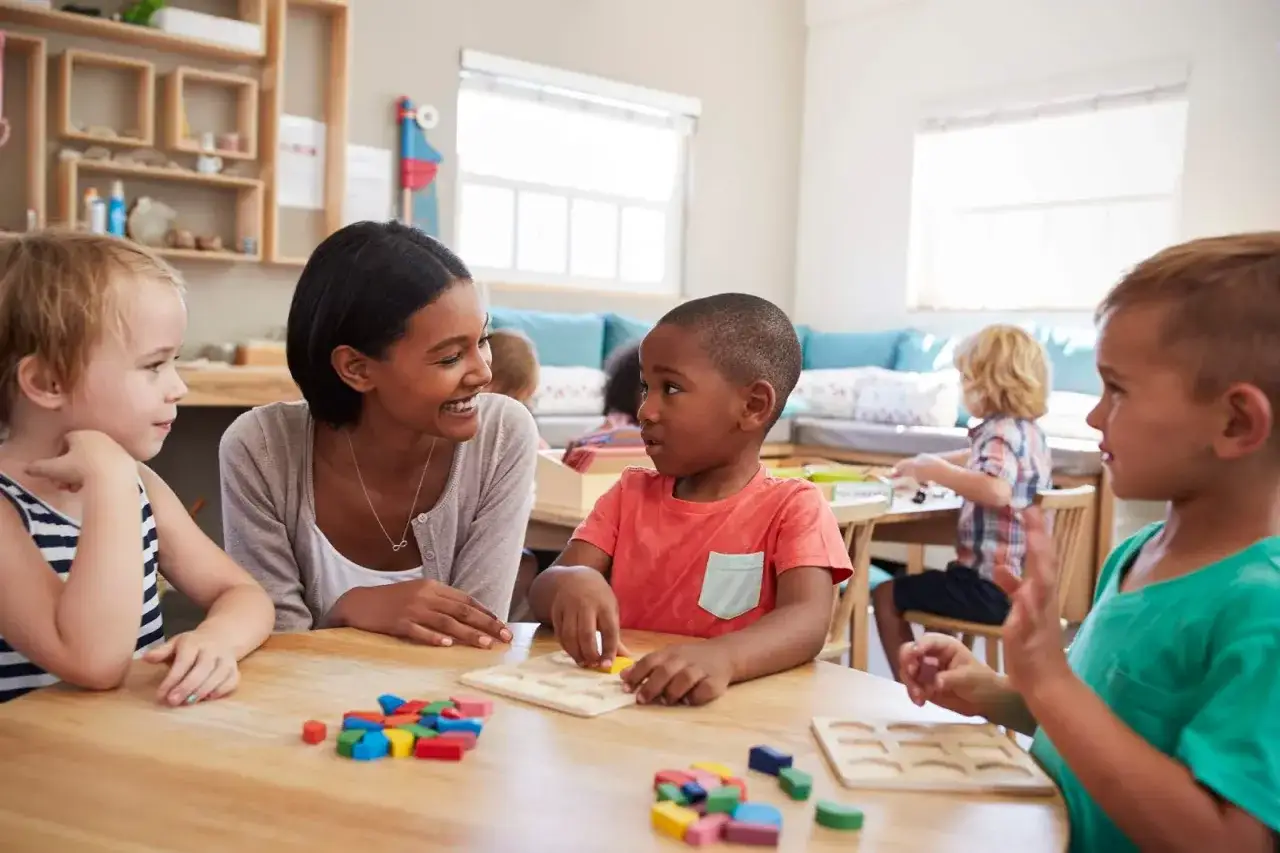 Children engage in hands-on learning with colorful blocks and puzzles, showcasing the interactive nature of Montessori education.