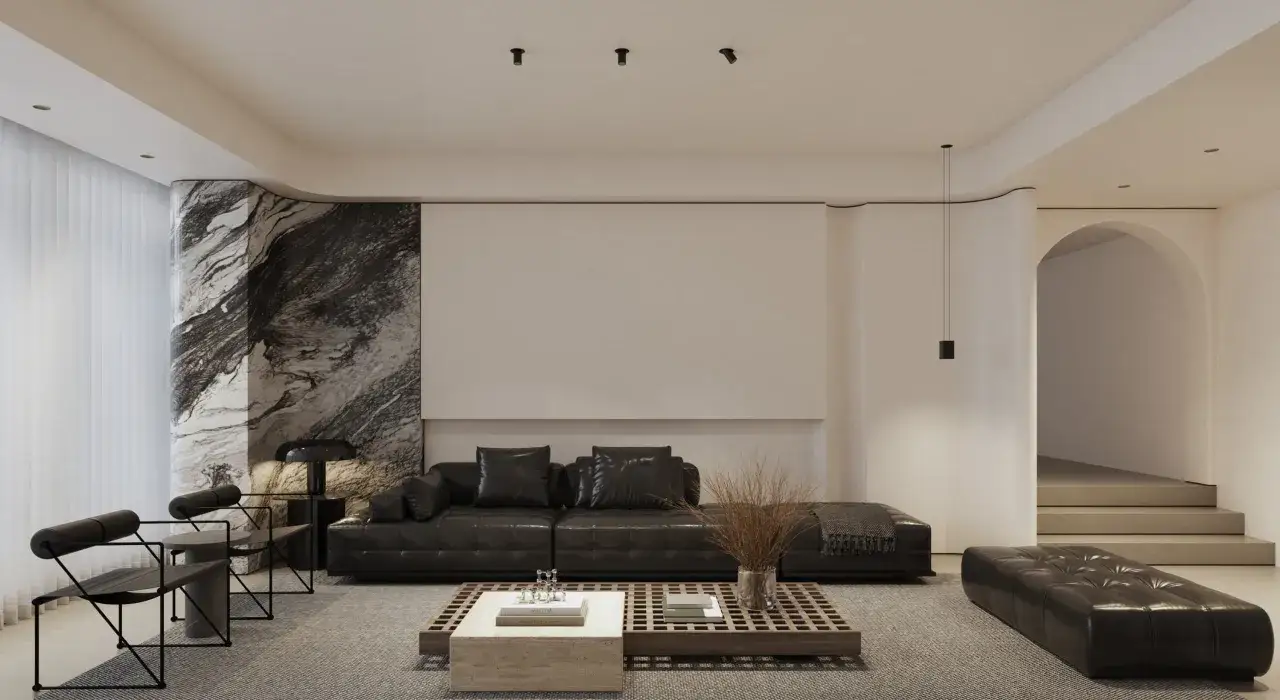 Nowoczesny salon z czarną, pikowaną kanapą, marmurowym słupem i minimalistycznym kinkietem spot.