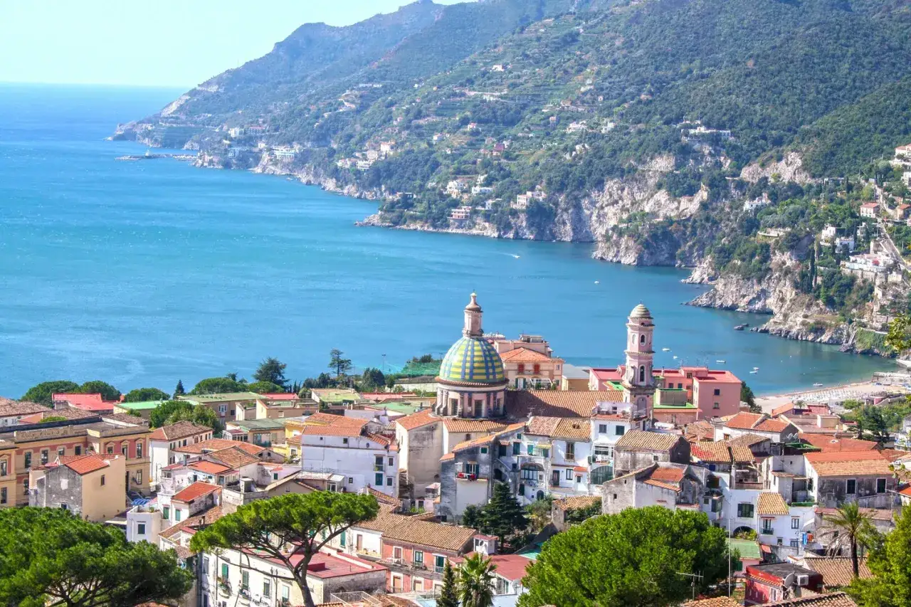 A picturesque view of towns near Naples, Italy, nestled along a stunning coastline. This scene resembles a vibrant map of coastal villages.