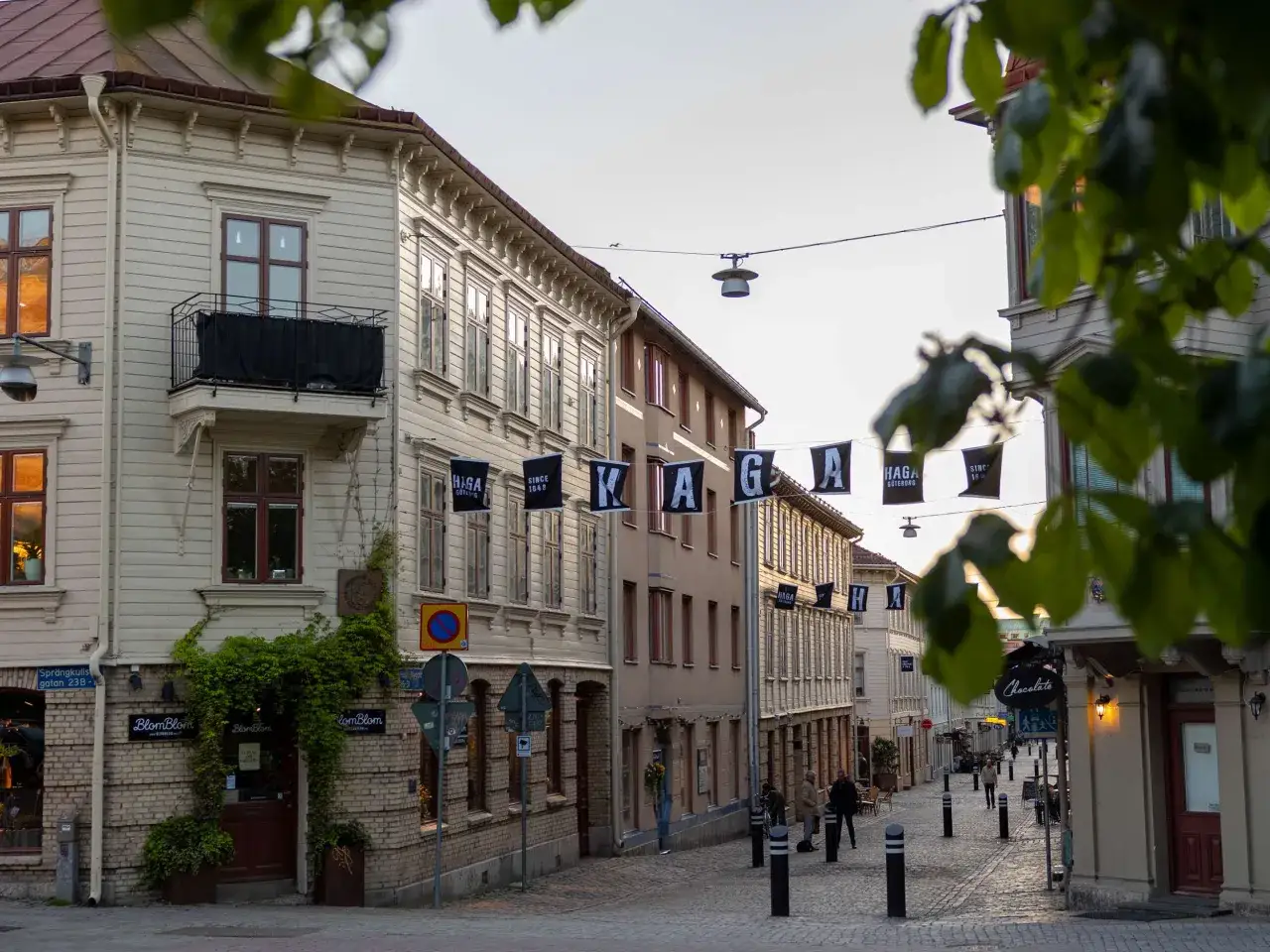 Gatorna i Haga, Göteborg, med flaggor som markerar en free walking tour. Vackra gamla hus och kullerstensgator.