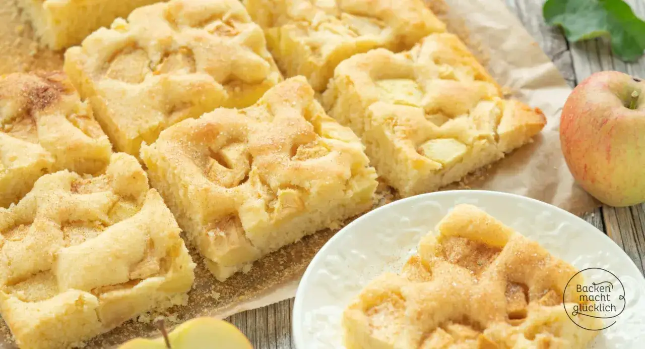 Saftiger Apfelkuchen, geschnitten in Stücke, bestreut mit Zucker und Zimt. Ein schneller Kuchen, der immer gelingt und glücklich macht.