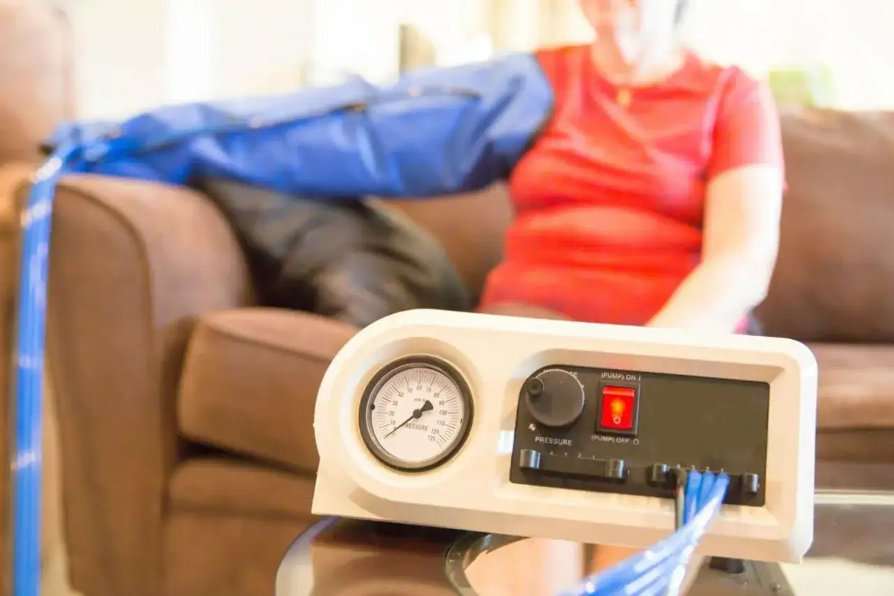 A person uses a lymphedema pump on their arm. Consult your doctor about how often you can use your lymphedema pump for best results.