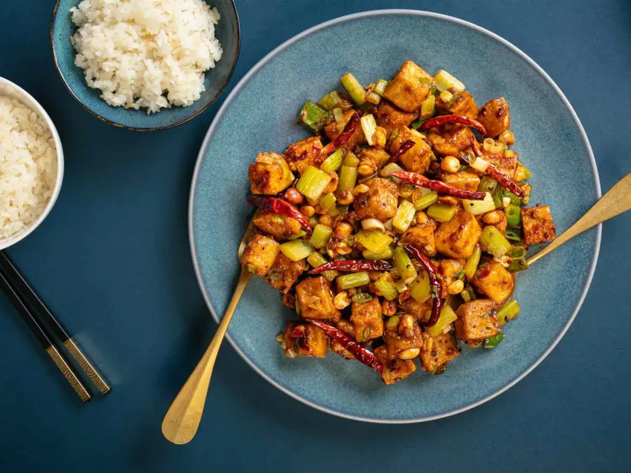 A flavorful dish of spicy japanese tofu with celery and peanuts, served with rice.